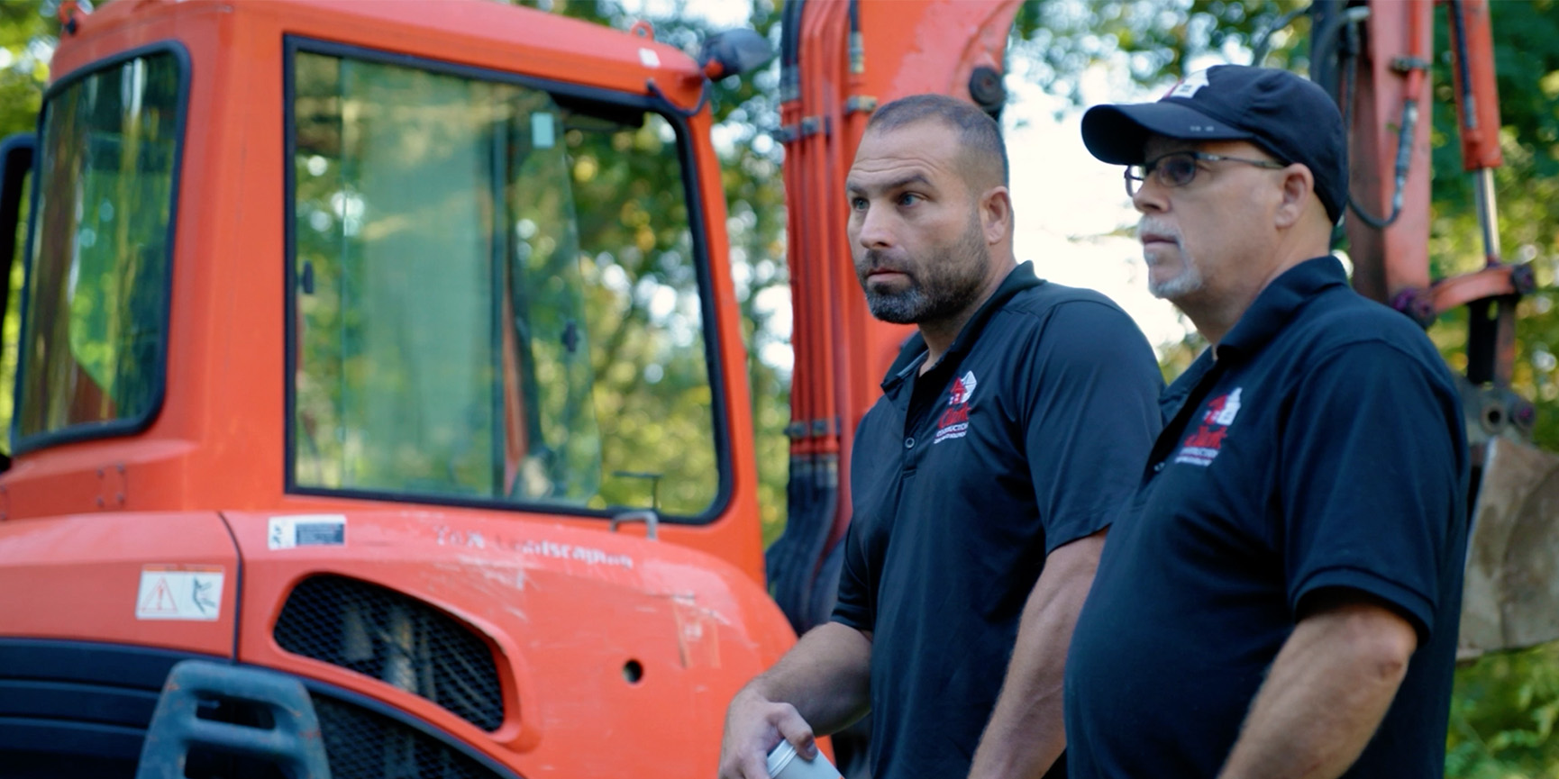 A remodeler and a homeowner standing in a finished kitchen in a Connecticut colonial, talking through the work.